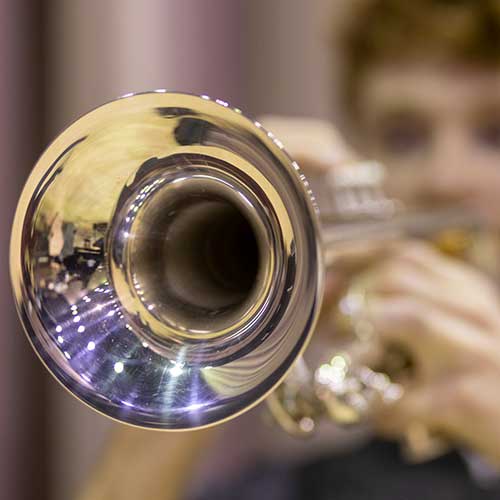 Male student plays trumpet