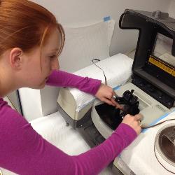 Loading tape into an infrared spectrophotometer.