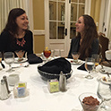 two students talking over a fancy dinner spread