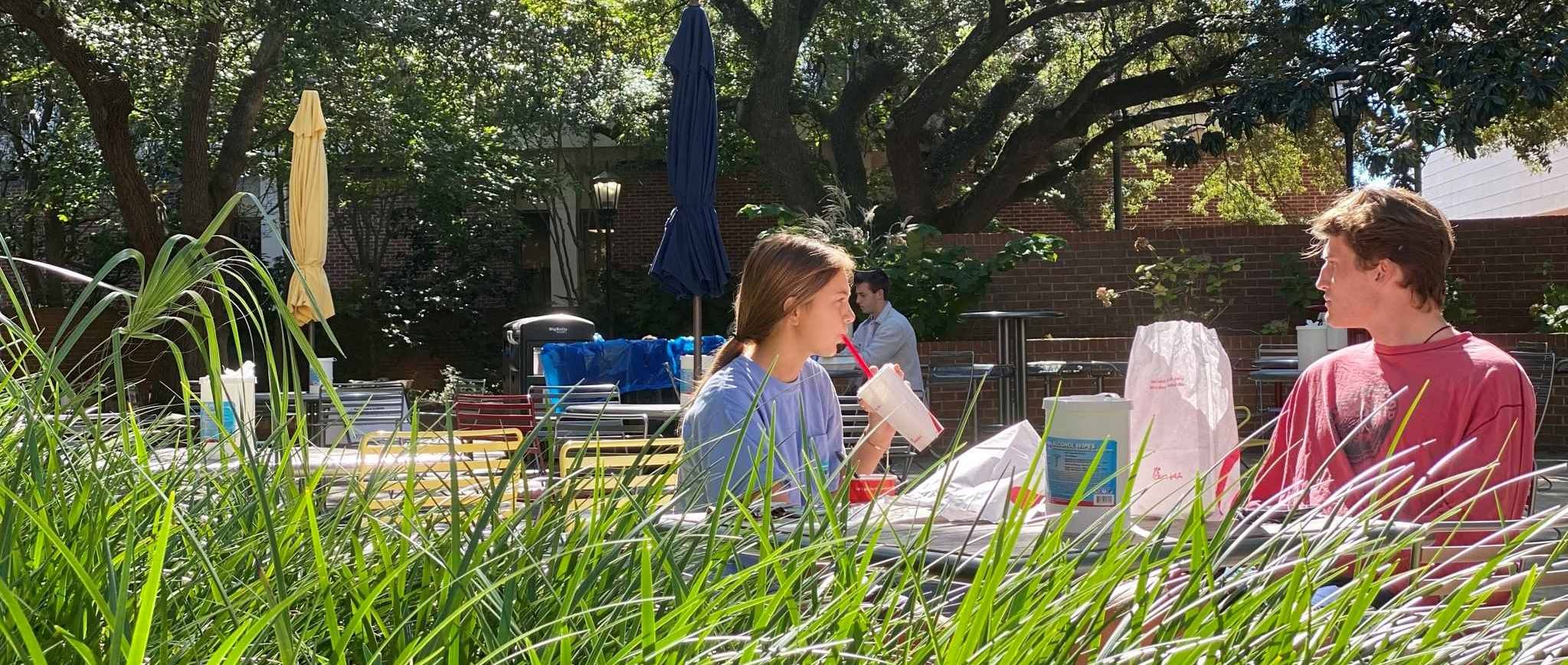 two people dining on a campus patio