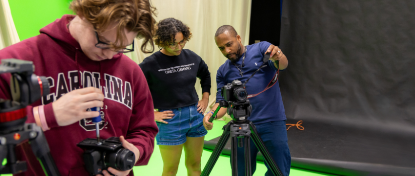 Students and instructor using equipment in our green screen lab