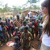 Jessica Gorman assists the children as they enter the Feeding Center