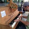 Darin Freeburg playing a "street piano" outside of the Rock and Roll Hall of Fame, one of 20 pianos scattered around the city of Cleveland, Ohio in summer 2013.