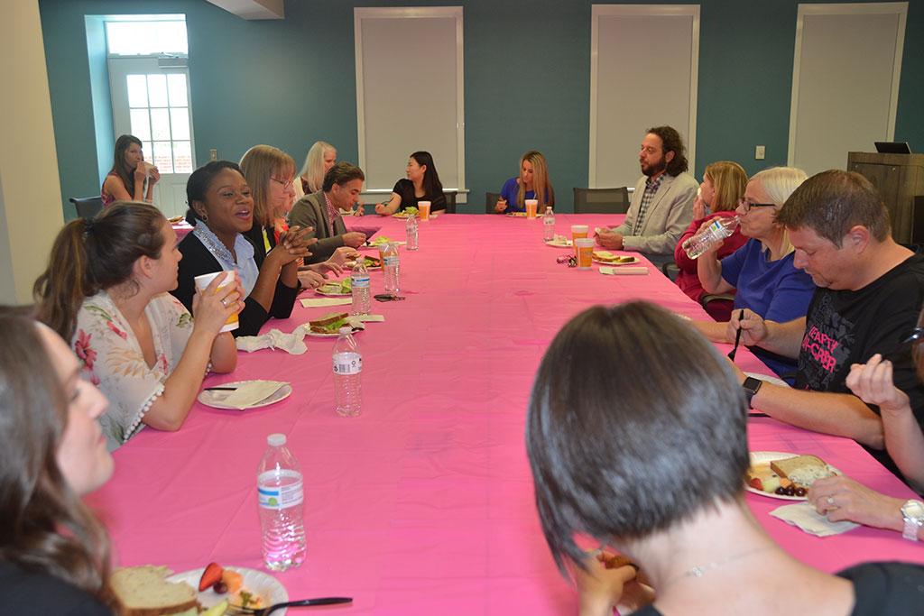 T-Mobile executives join advertising students for lunch. Yes, the table is magenta and shaped in a T.