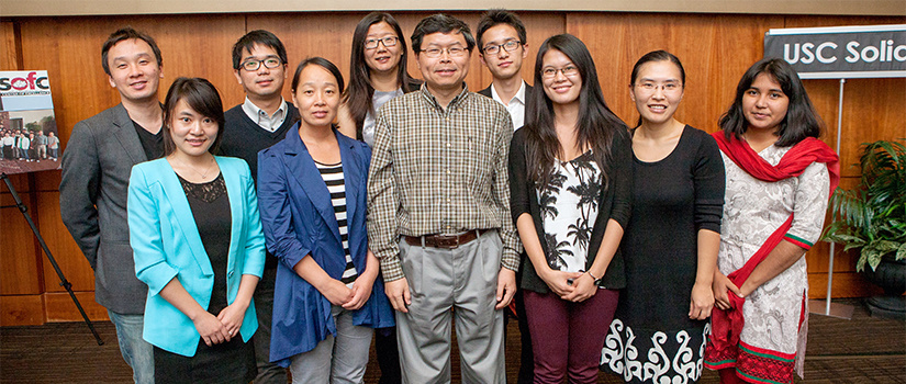 Dr. Huang at a conference with a group of grad students