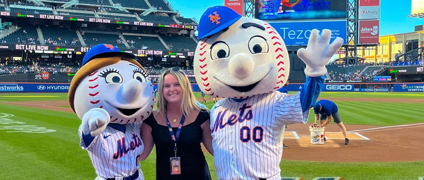 Student Kayla Shannon poses for a photo with mascots Mr. and Mrs. Met while doing an internship for the the New York Mets MLB franchise.