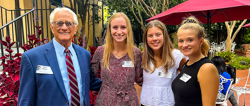 Donor Bert Pooser poses for a photo with HRSM students Caitlin Ansel, Lexi Bado and Sydney Accomando.