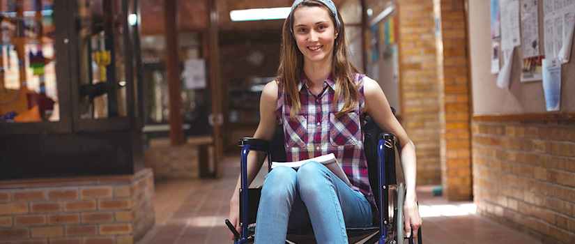 A young woman in a wheelchair smiles