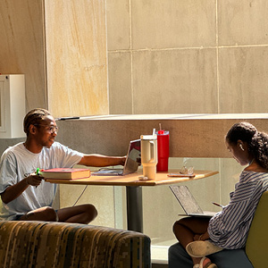 Two students studying at a booth in Russell House.
