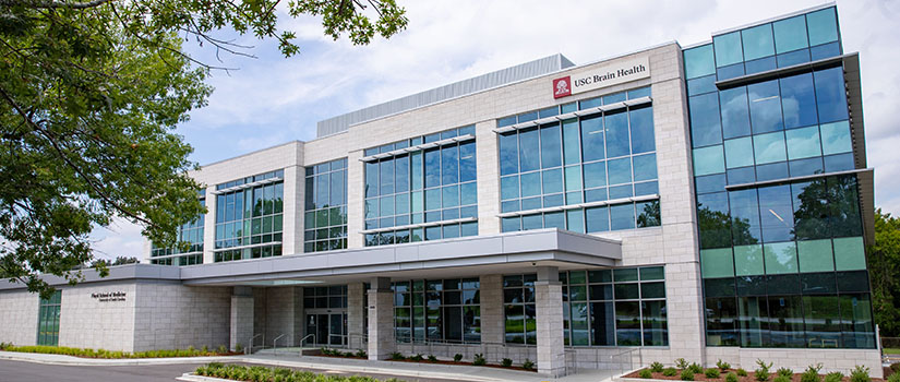 A digitally rendered image of the exterior of a big business building that reads "School of Medicine Columbia" on the outside.