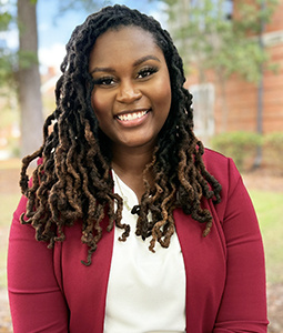 Headshot of Aliyah Little outdoors.