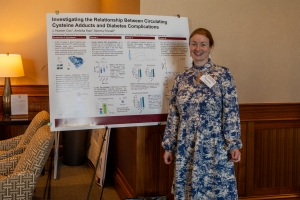 Norma Frizzell with poster at ClinTrUSC Annual Meeting