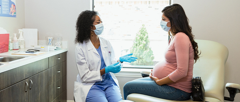 A medical provider talking with a pregnant woman