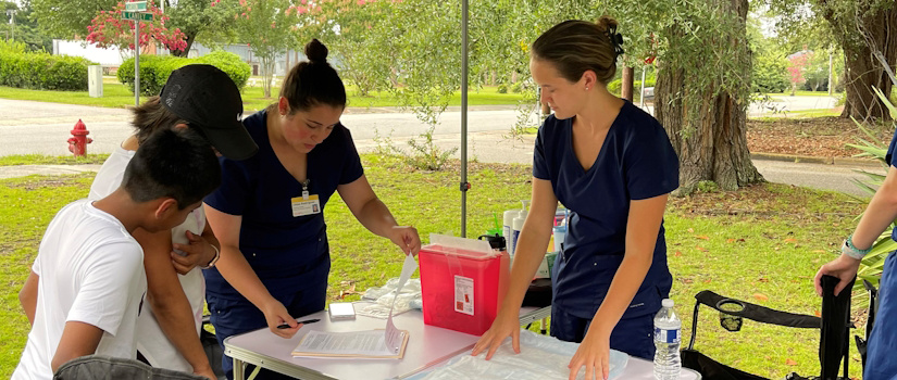 Students helping with a vaccine clinic outside