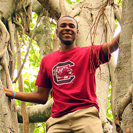 student standing among trees in Australia 