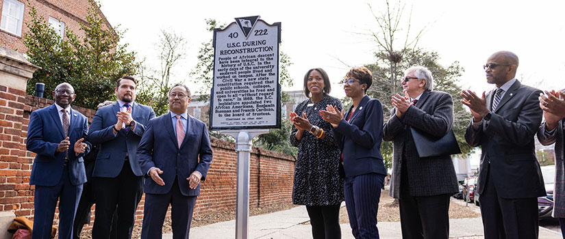 Community and university officials unveiling historical marker