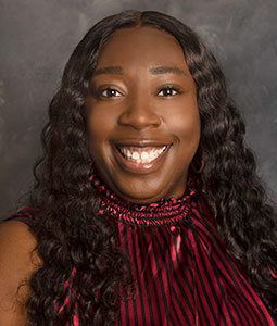 Cierra is an African-American female who is picture from the shoulders up. She has long black hair, brown eyes, and is smiling. 