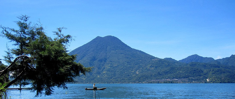 a volcano with a lake in the foreground