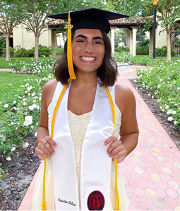 a smiling woman in a graduation cap