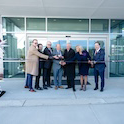 group of people cutting a garnet ribbon