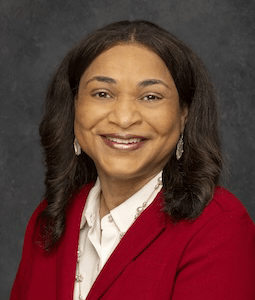 woman in red blazer smiling
