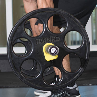 A close up of the side view of a set of weights that a student is lifting.