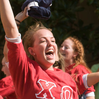 Sorority member cheering and performing during an event.