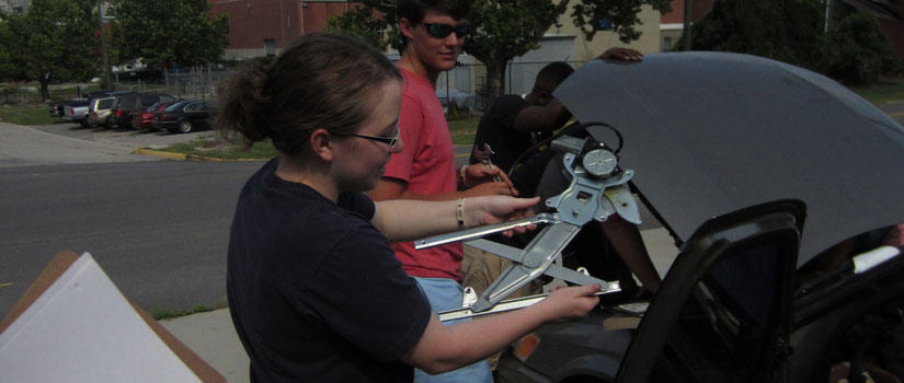 Engineering students working with tools