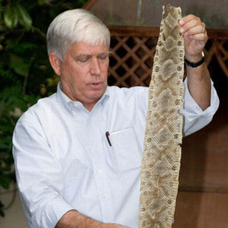 Instructor Rudy Mancke holding a snake skiin