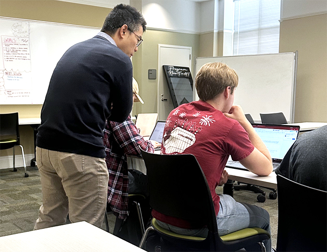 Matthew Lai in classroom with students