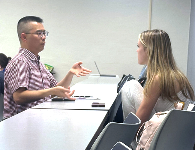 Matthew Lai in classroom with students
