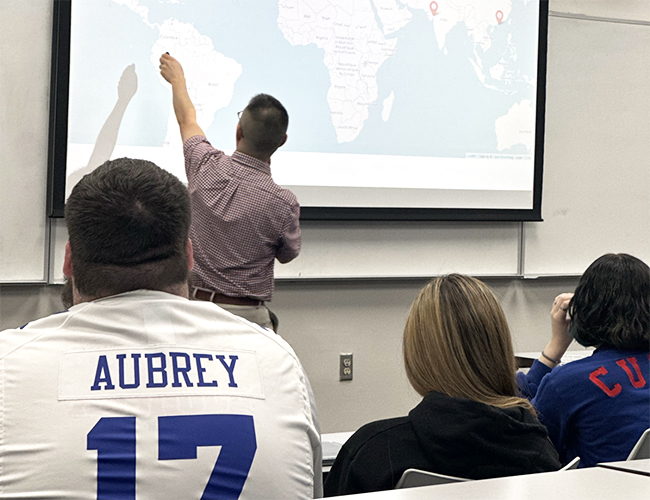Matthew Lai in classroom with students