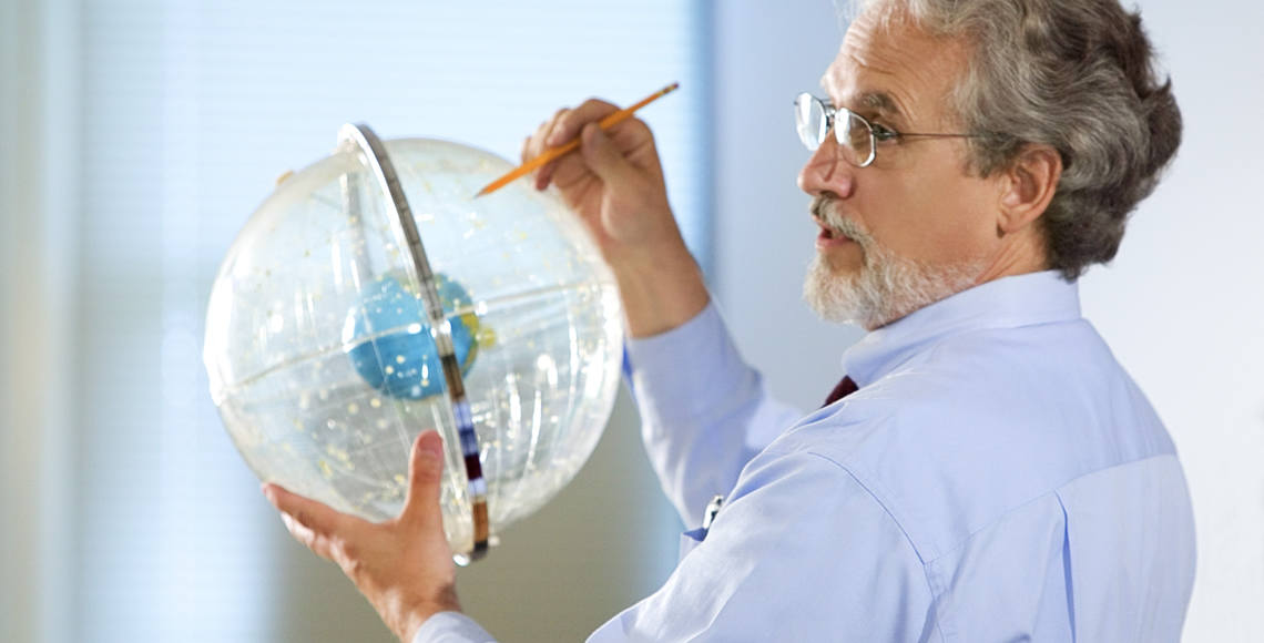 Professor Holding Astronomical Globe
