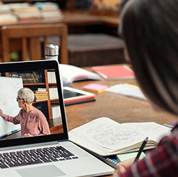 Students watching an online course on laptop