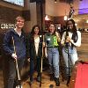 Four students pose with billiards sticks