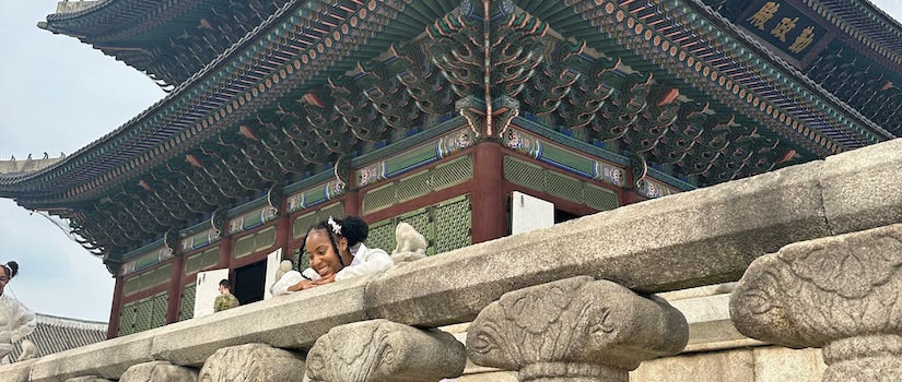 a student looking over a balcony on a pagoda in South Korea