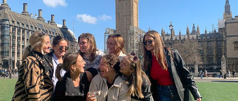 a group of students smiling in front of Big Ben