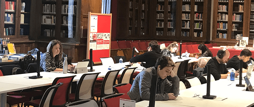 students sitting in a library studying
