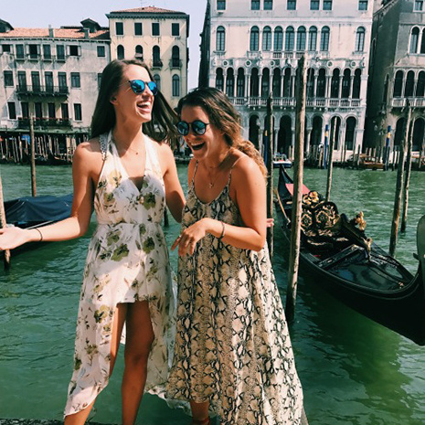 two students standing on a canal in Venice, Italy