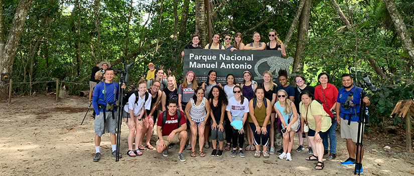 Group of students stands in front of a national park sign