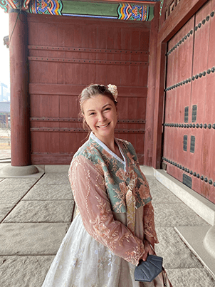 Anne Tumlin wearing a traditional hanbok while exploring Gyeongbokgung Palace in Seoul.