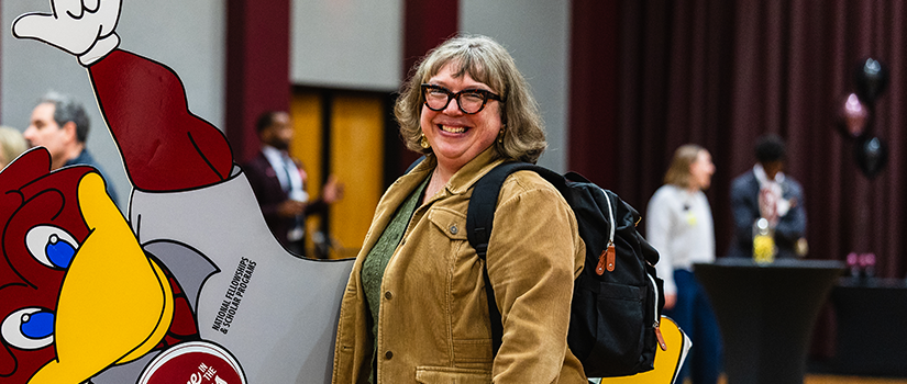 Jennifer Bess posing for a photo in the Russell House ballroom