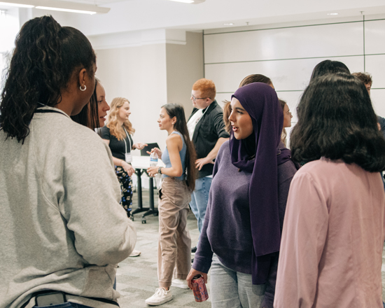 Group of students connecting during a national fellowships event in the Honors Residence Hall.