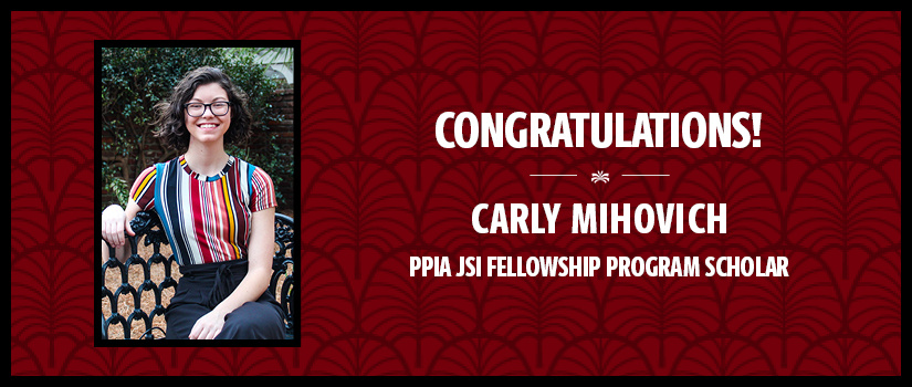 Carly sitting on a bench on the Horseshoe.