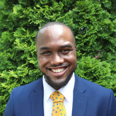 william's headshot, in front of greenery