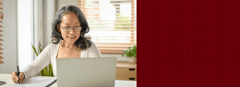 Mature woman working on laptop at desk