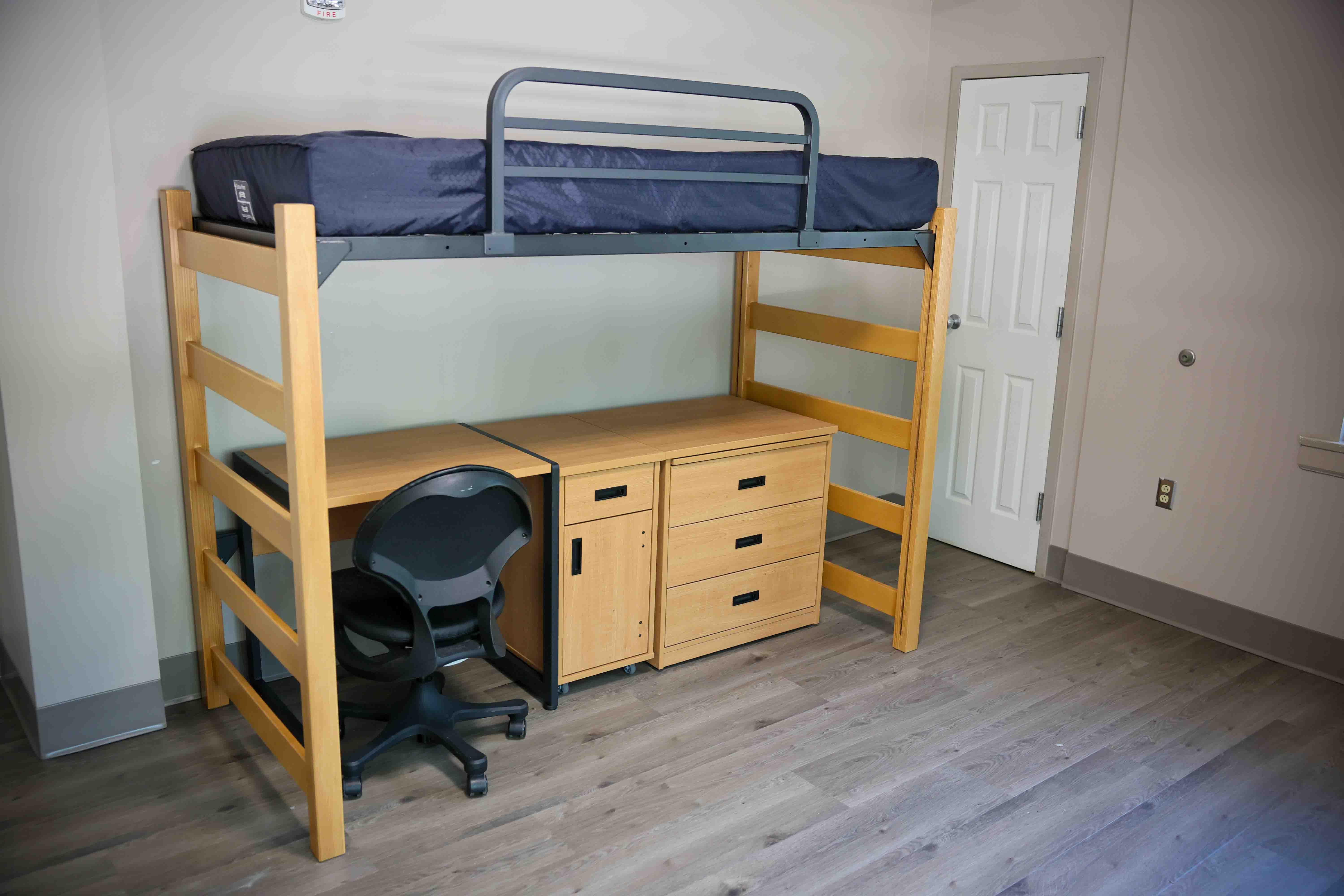 Freshly updated with new wood-look flooring, this residence hall room offers a comfortable lofted sleeping area, functional study space, and plenty of storage.