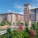 Building one in campus village featuring the clock tower on the six story building