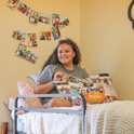 Student sitting on their bed