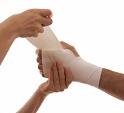 Nurse wrapping hand with bandage